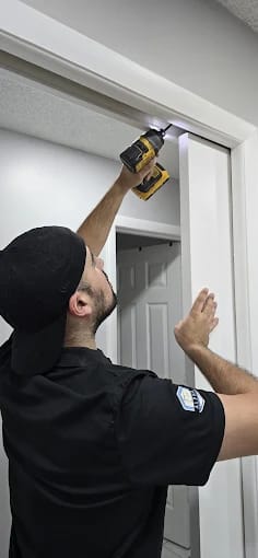 Professional technician working on pocket door- no wall damage