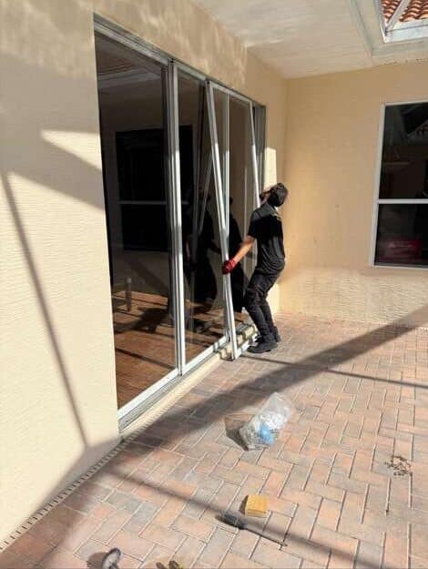 Technician lifting sliding door