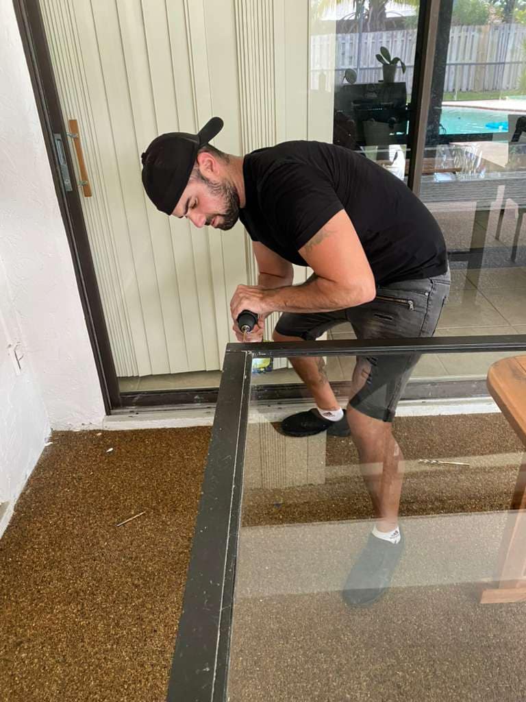 Technician working on sliding glass door